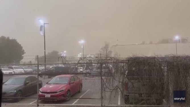 Dust fills a parking lot in Tulare, California.