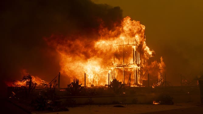 A house is engulfed in the flames of the Mountain Fire as the wildfire scorches acres in Camarillo Heights, Camarillo, California, on November 6, 2024.