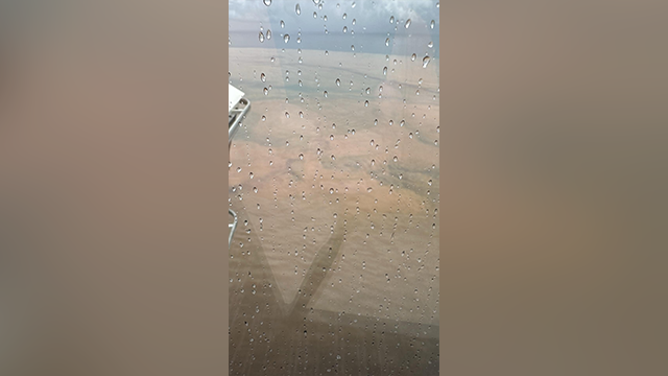 This image shows mud and debris off the Honduras coast at Roatan due to torrential rain from Tropical Depression Nineteen.